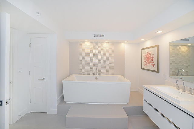 bathroom with tile patterned flooring, vanity, and a bathtub