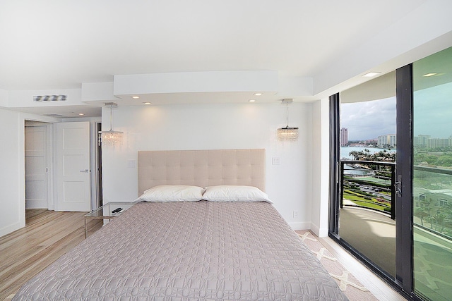 bedroom featuring light hardwood / wood-style floors and access to exterior