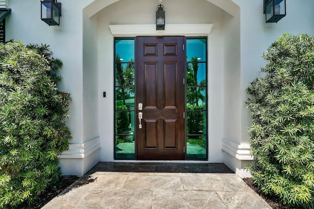 doorway to property with stucco siding