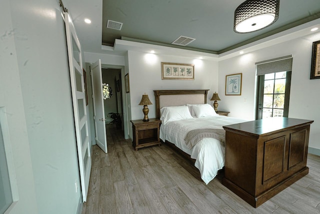 bedroom with recessed lighting, light wood-style floors, and visible vents