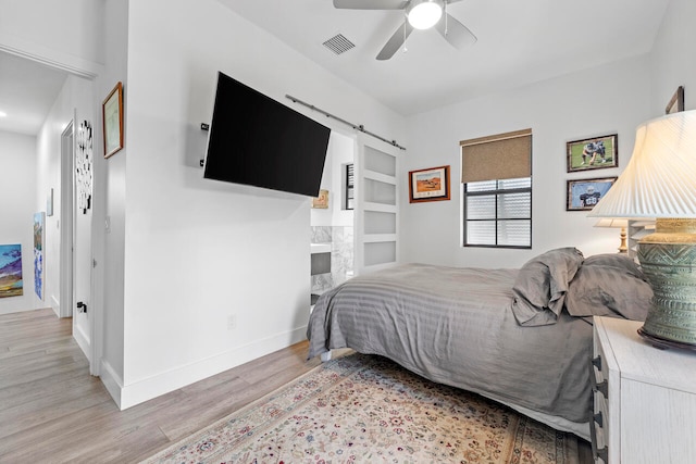 bedroom with light wood-type flooring and ceiling fan