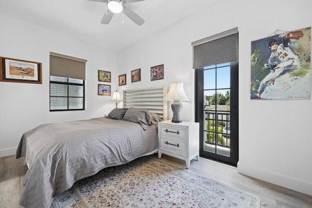 bedroom featuring baseboards, light wood-style floors, ceiling fan, and access to outside