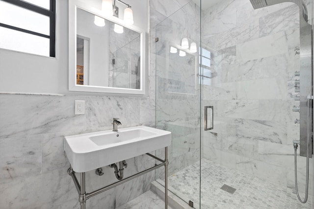 bathroom featuring a shower with shower door and tile walls