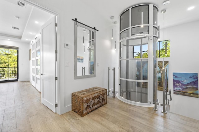 corridor featuring baseboards, visible vents, wood finished floors, and recessed lighting