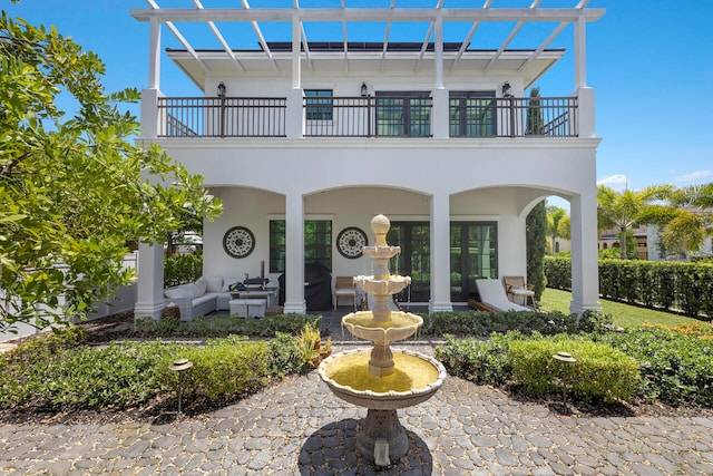 exterior space featuring a pergola, outdoor lounge area, a patio area, and a balcony