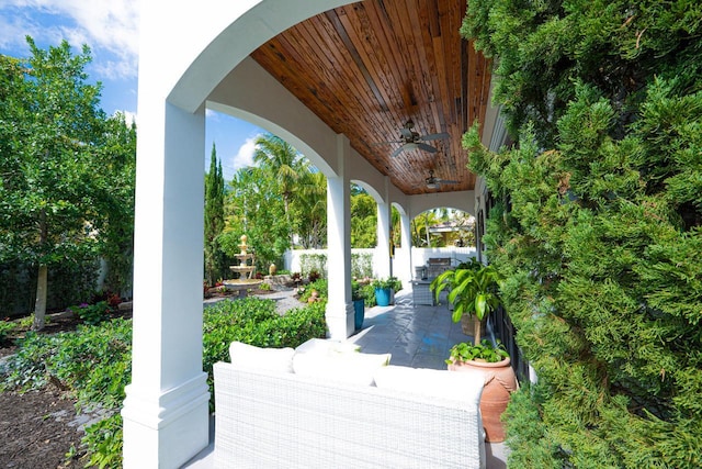 view of patio with ceiling fan and fence