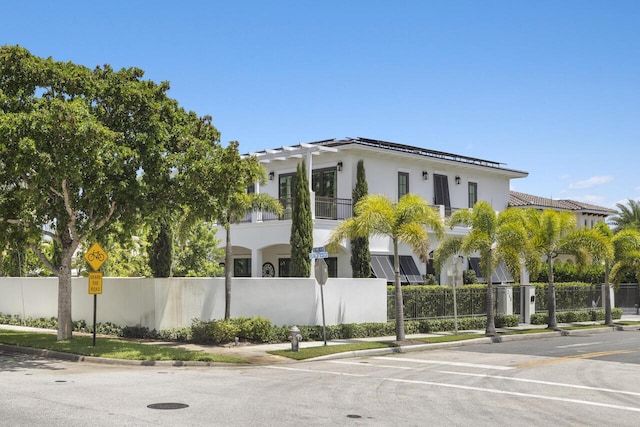 exterior space with a fenced front yard and stucco siding