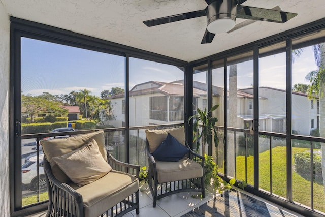 sunroom / solarium featuring ceiling fan