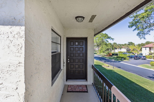 entrance to property with stucco siding