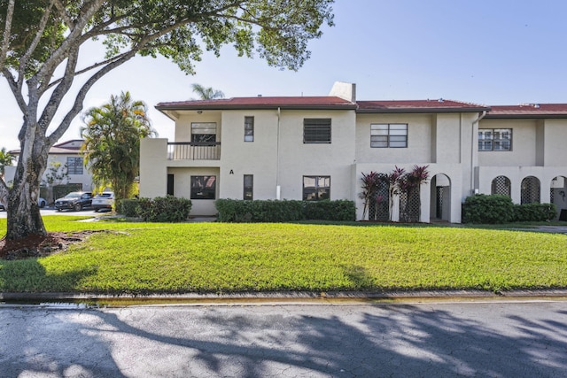 view of front of property with a front lawn and stucco siding