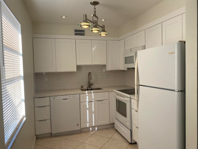 kitchen with white appliances, white cabinets, sink, tasteful backsplash, and light tile patterned flooring