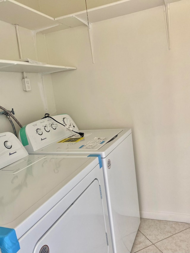 laundry room featuring washer and dryer and light tile patterned floors