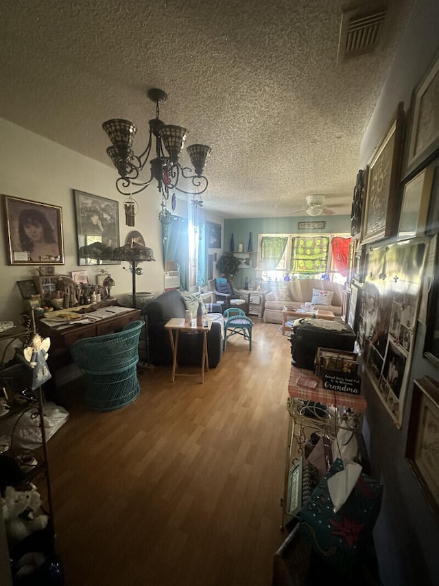 interior space featuring a chandelier, a textured ceiling, and hardwood / wood-style flooring