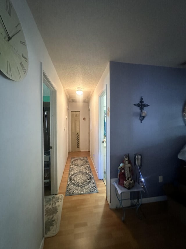 corridor with hardwood / wood-style floors