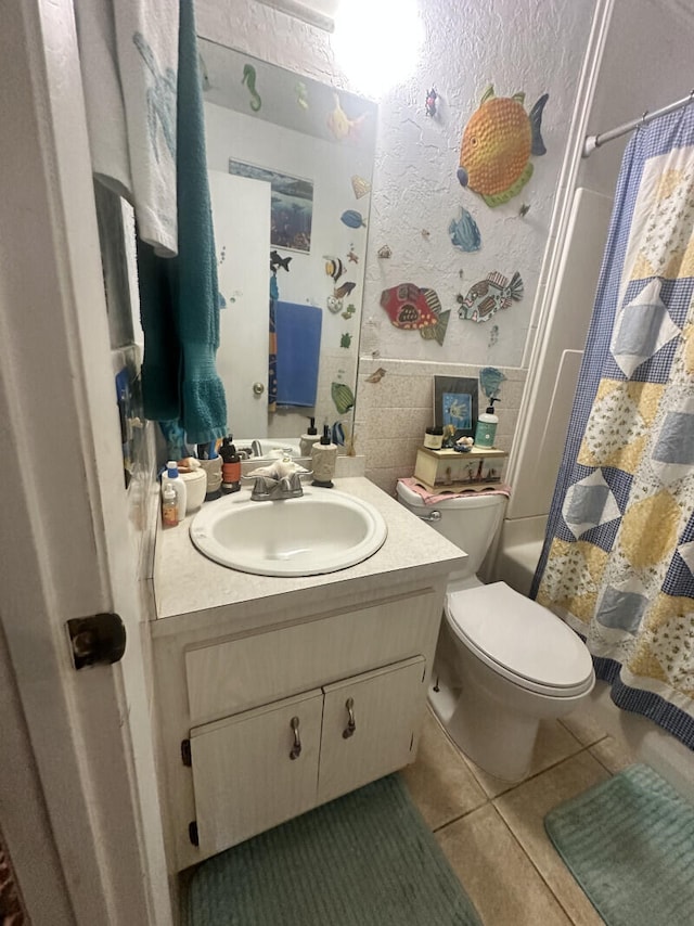 full bathroom with tile patterned floors, vanity, toilet, and shower / bathtub combination with curtain