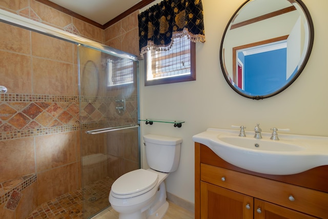 bathroom featuring a shower with door, toilet, and vanity