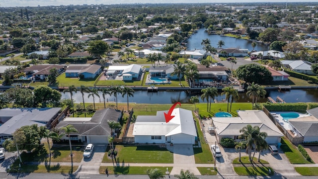 drone / aerial view featuring a water view and a residential view