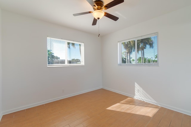 empty room with light hardwood / wood-style floors and ceiling fan