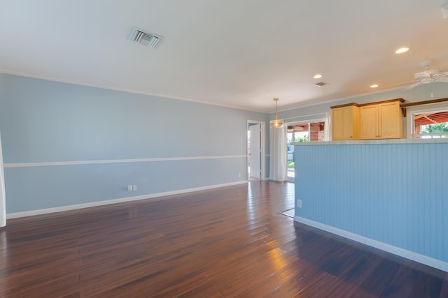 interior space featuring ceiling fan, dark hardwood / wood-style floors, a wealth of natural light, and crown molding