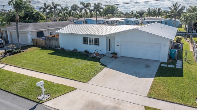 ranch-style home featuring a garage and a front yard