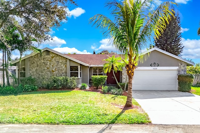 ranch-style house featuring a garage and a front lawn