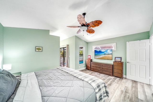 bedroom with light hardwood / wood-style floors, vaulted ceiling, and ceiling fan