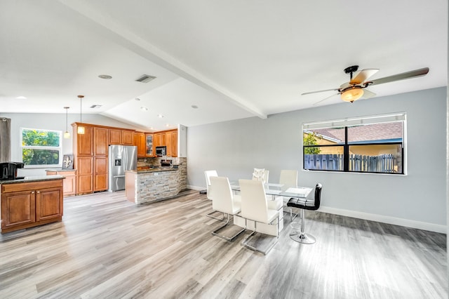 dining space featuring vaulted ceiling, light hardwood / wood-style flooring, plenty of natural light, and ceiling fan