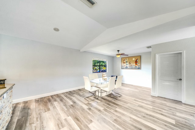 unfurnished dining area featuring light hardwood / wood-style flooring, ceiling fan, and lofted ceiling