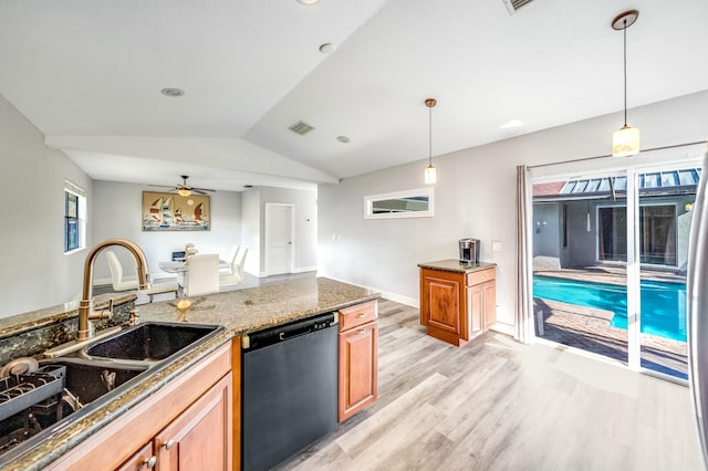 kitchen featuring dishwasher, hanging light fixtures, vaulted ceiling, ceiling fan, and light wood-type flooring