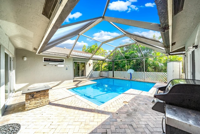 view of swimming pool featuring a patio and a lanai