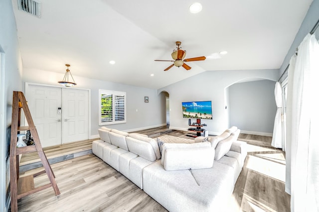 living room with ceiling fan, light hardwood / wood-style floors, and lofted ceiling