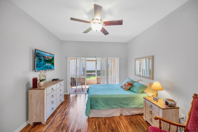 bedroom featuring access to outside, ceiling fan, and dark wood-type flooring