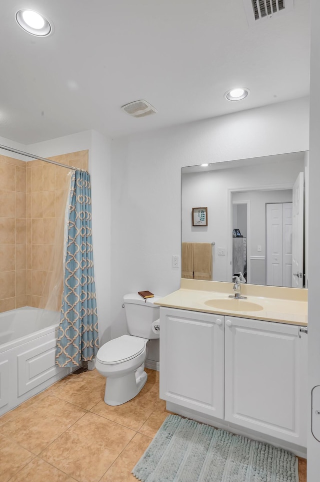 full bathroom featuring tile patterned floors, shower / bath combo with shower curtain, vanity, and toilet