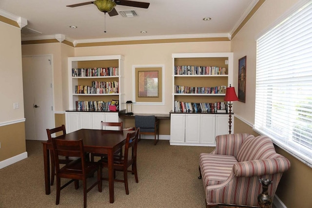 dining room featuring carpet floors, built in features, ceiling fan, and ornamental molding