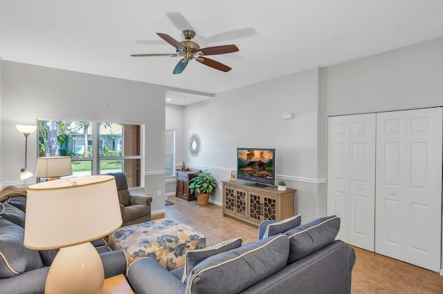 tiled living room with ceiling fan