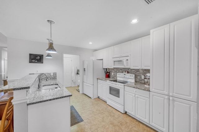 kitchen with white appliances, white cabinets, sink, light tile patterned floors, and decorative light fixtures