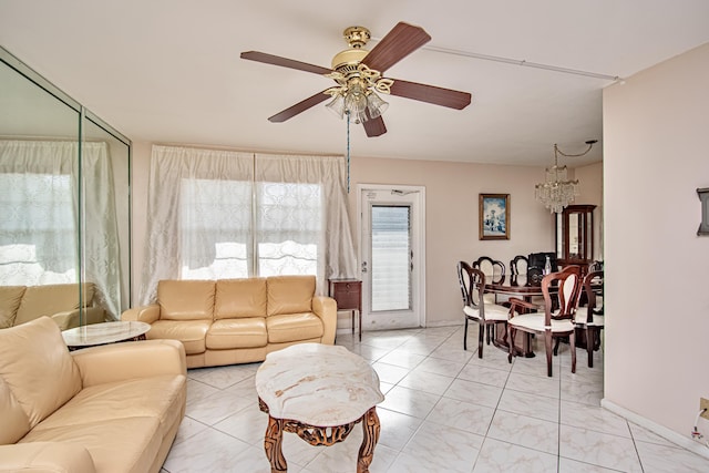 living room featuring ceiling fan with notable chandelier