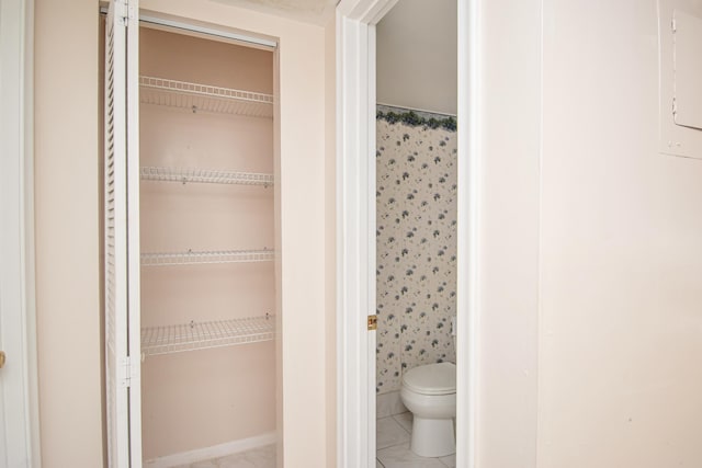 bathroom featuring tile patterned floors and toilet