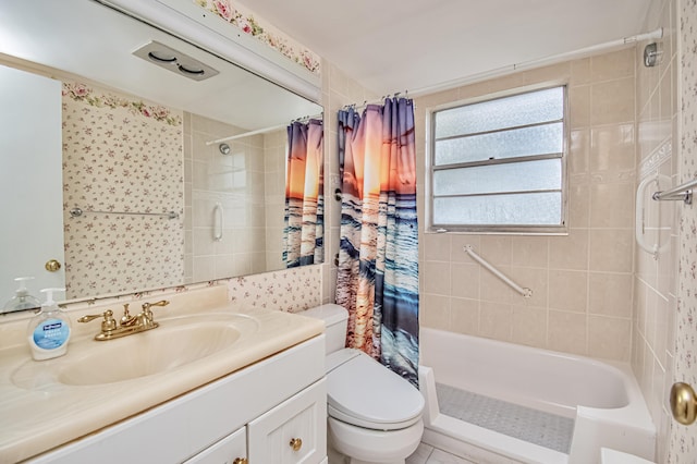 full bathroom featuring tile patterned flooring, vanity, toilet, and shower / bath combo with shower curtain