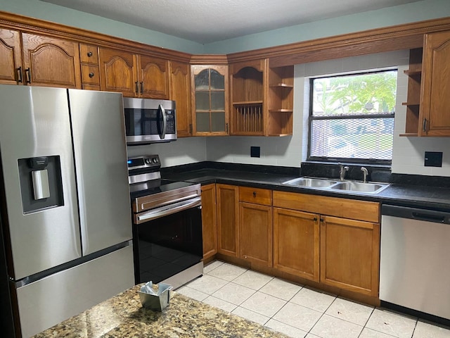 kitchen featuring sink, light tile patterned floors, and stainless steel appliances