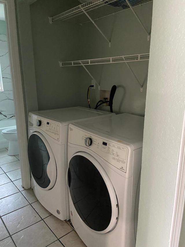 washroom with light tile patterned flooring and independent washer and dryer