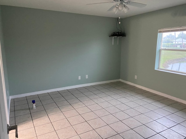 unfurnished room with light tile patterned floors and ceiling fan