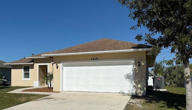 ranch-style house featuring a garage and central air condition unit