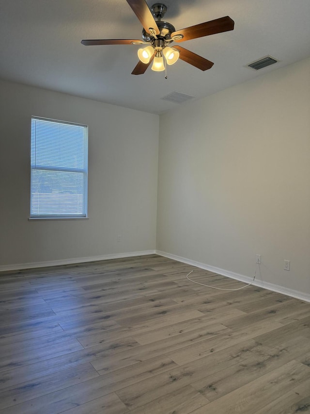 empty room with ceiling fan and wood-type flooring