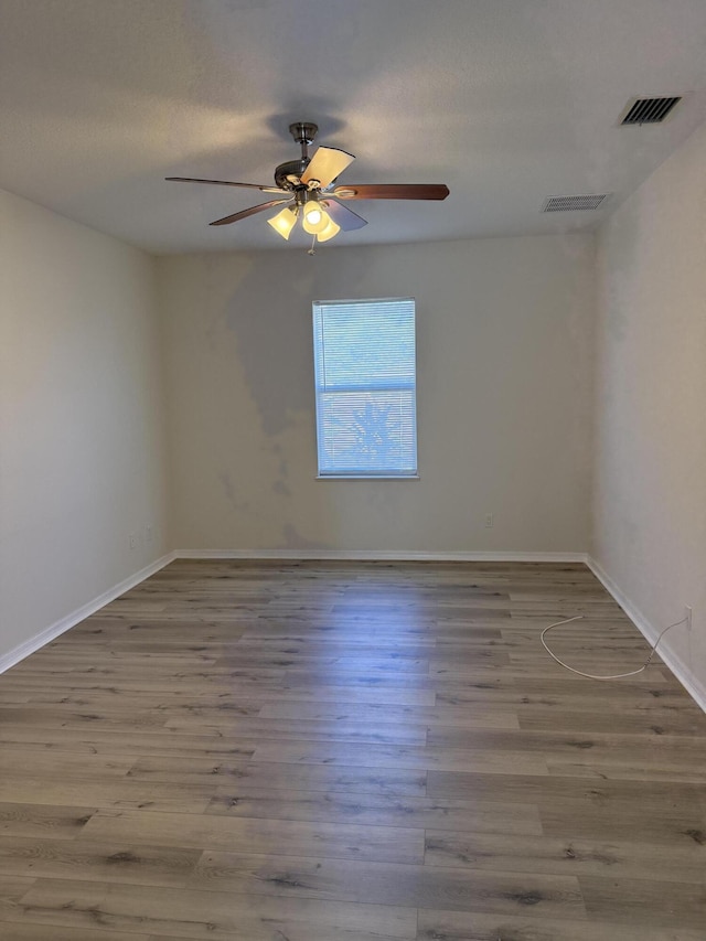 spare room with ceiling fan and hardwood / wood-style floors