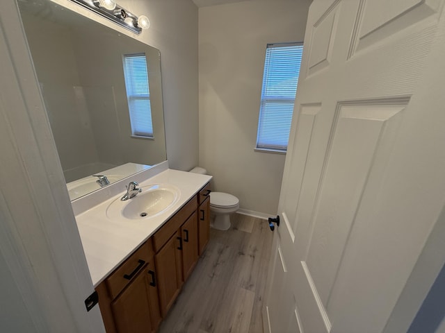 bathroom featuring vanity, hardwood / wood-style flooring, and toilet