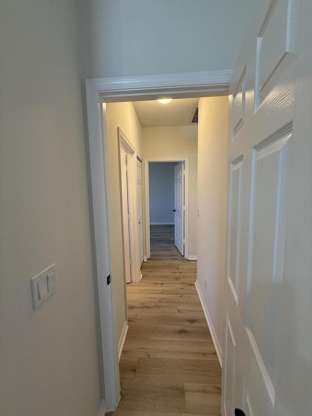 hallway with light wood-type flooring