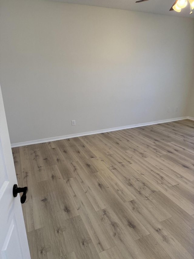 spare room with ceiling fan and light hardwood / wood-style flooring