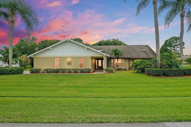 ranch-style house with a yard