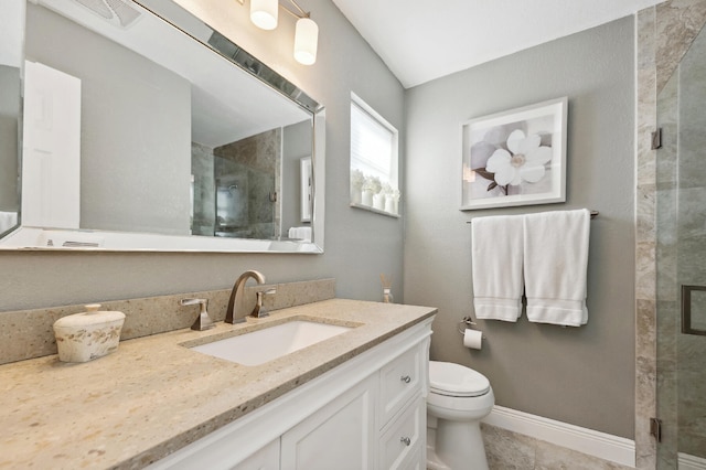 bathroom featuring toilet, vanity, tile patterned floors, and an enclosed shower